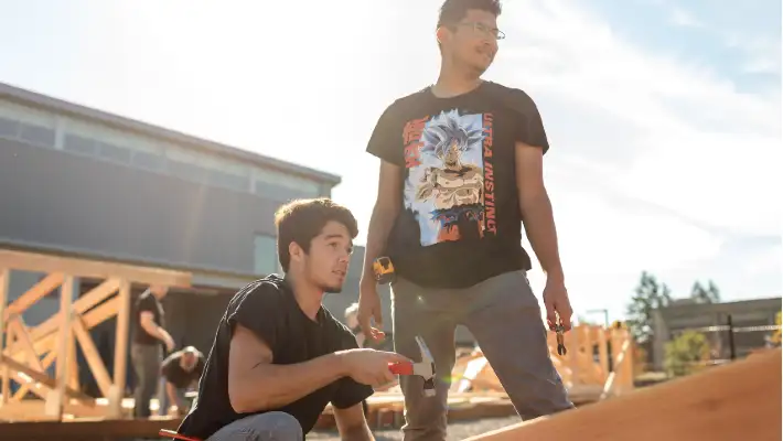 Two students standing in a construction site